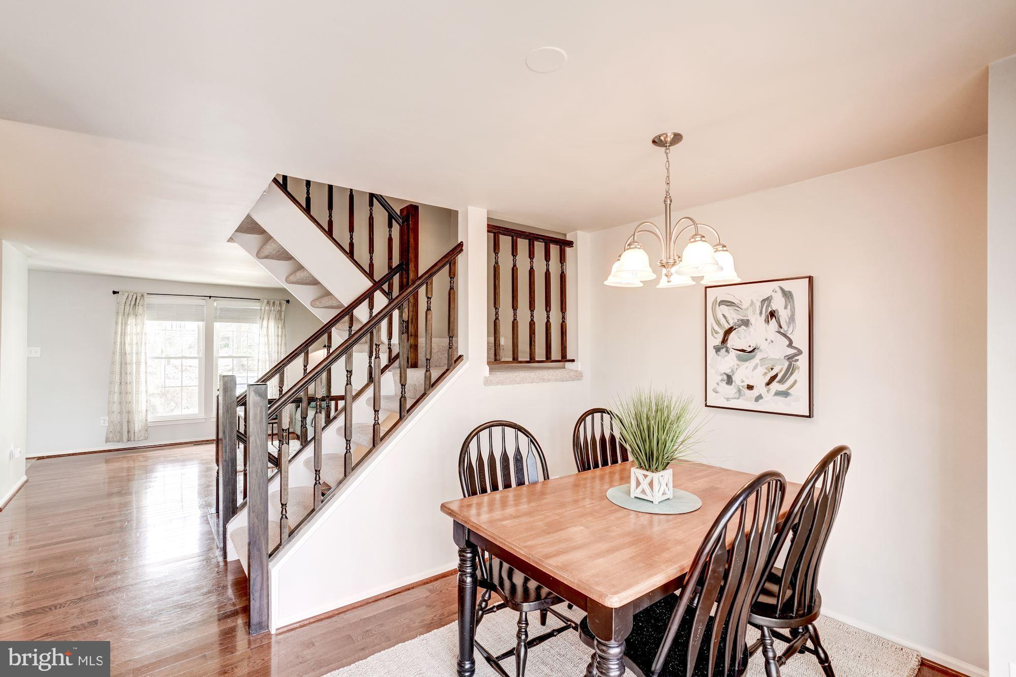 10968 Granby Court Reston, VA 20191 - Photo 8 of 33 a dining room with furniture entryway and wooden floor
