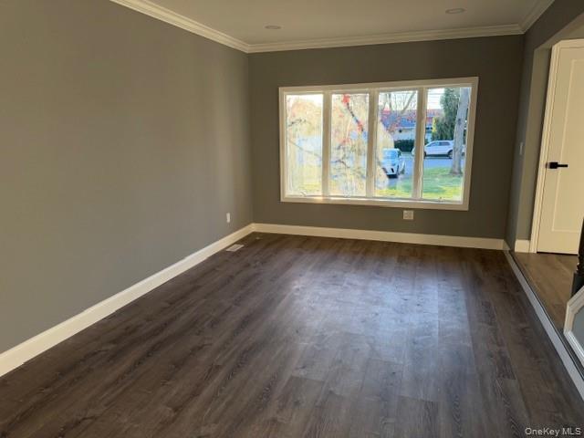 95 Muncie Road West Babylon, NY 11704 - Photo 1 of 13 an empty room with wooden floor and windows