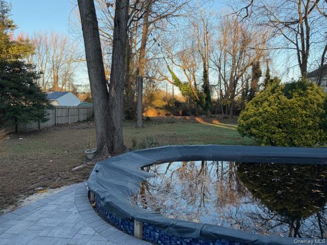 95 Muncie Road West Babylon, NY 11704 - Photo 11 of 13 a view of wooden fence and large trees