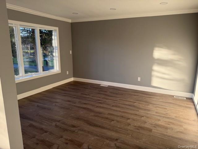 95 Muncie Road West Babylon, NY 11704 - Photo 3 of 13 a view of an empty room with wooden floor and a window