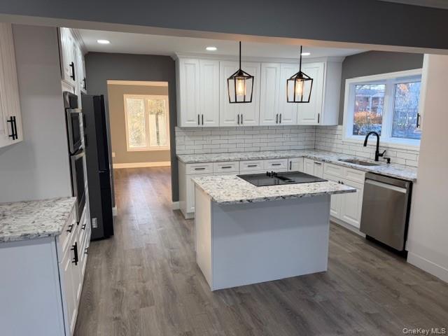 95 Muncie Road West Babylon, NY 11704 - Photo 4 of 13 a kitchen with granite countertop a sink stove and cabinets
