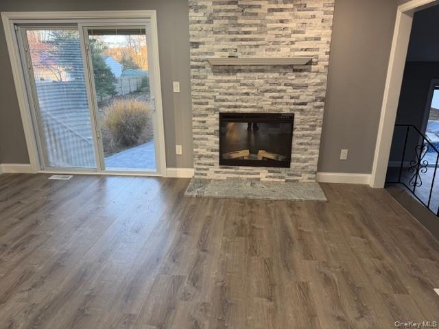 95 Muncie Road West Babylon, NY 11704 - Photo 5 of 13 a view of an empty room with wooden floor fireplace and a window