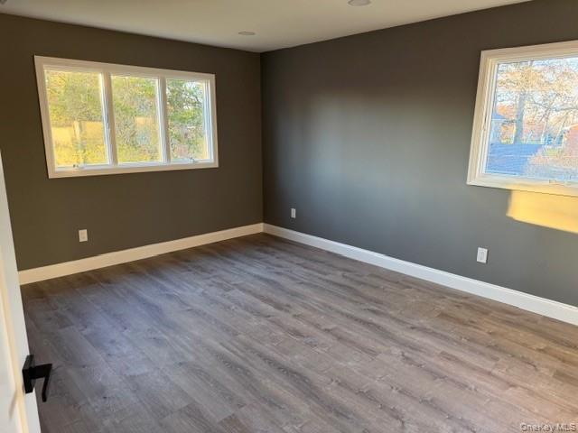 95 Muncie Road West Babylon, NY 11704 - Photo 7 of 13 a view of an empty room with wooden floor and a window