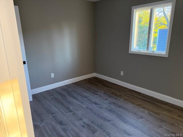 95 Muncie Road West Babylon, NY 11704 - Photo 8 of 13 a view of an empty room with wooden floor and a window