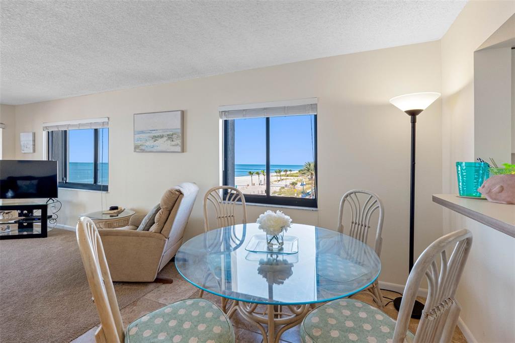 15000 Gulf Boulevard, Unit 408 Madeira Beach, FL 33708 - Photo 14 of 35 a dining room with furniture and a potted plant