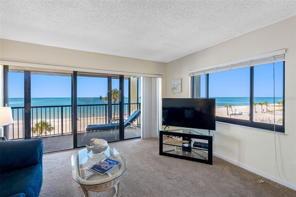 15000 Gulf Boulevard, Unit 408 Madeira Beach, FL 33708 - Photo 16 of 35 a living room with furniture and a flat screen tv