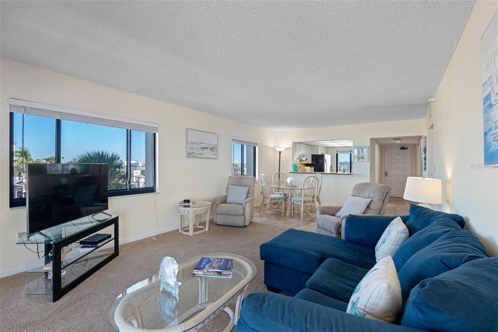 15000 Gulf Boulevard, Unit 408 Madeira Beach, FL 33708 - Photo 19 of 35 a living room with furniture and a flat screen tv