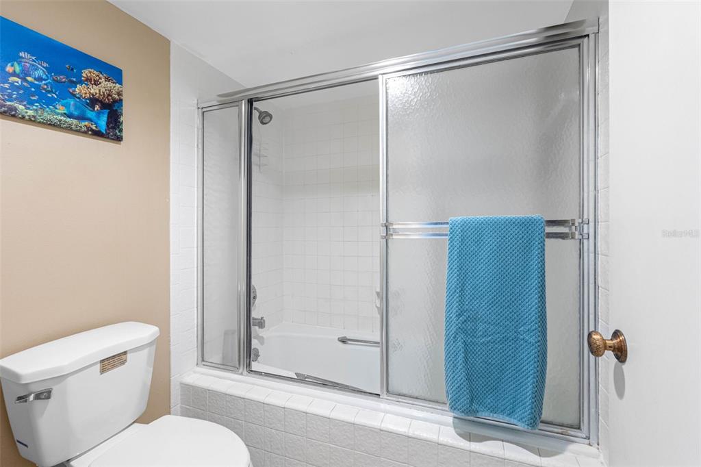 15000 Gulf Boulevard, Unit 408 Madeira Beach, FL 33708 - Photo 23 of 35 a bathroom with a shower and a toilet