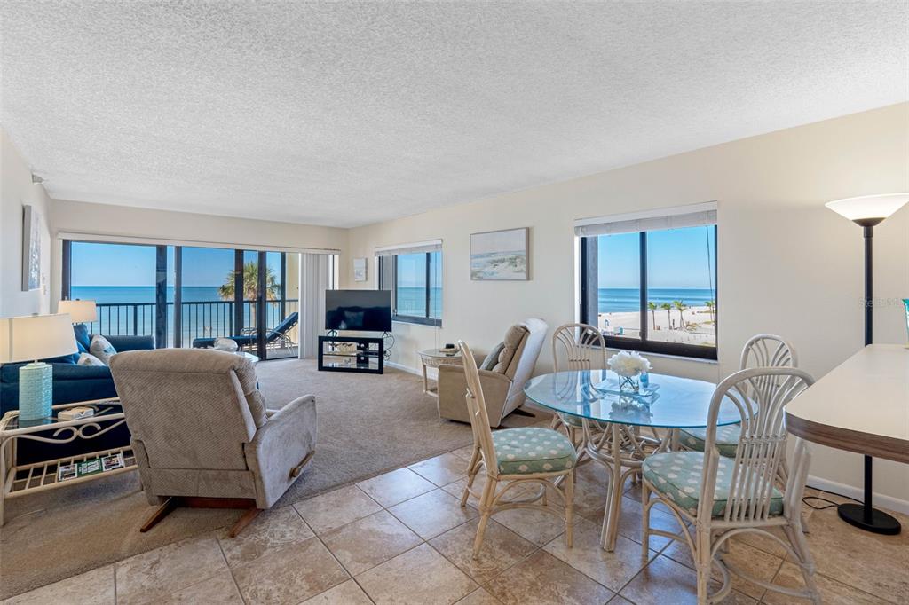 15000 Gulf Boulevard, Unit 408 Madeira Beach, FL 33708 - Photo 3 of 35 a living room with furniture a lamp and a window