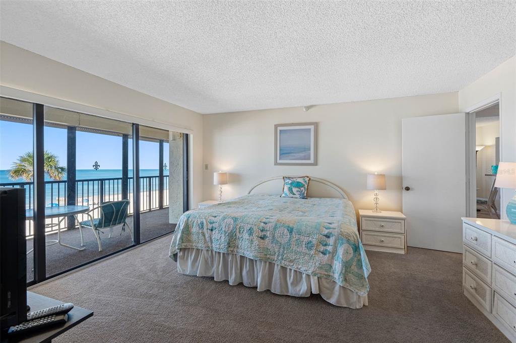 15000 Gulf Boulevard, Unit 408 Madeira Beach, FL 33708 - Photo 5 of 35 a bedroom with a bed and a night stand