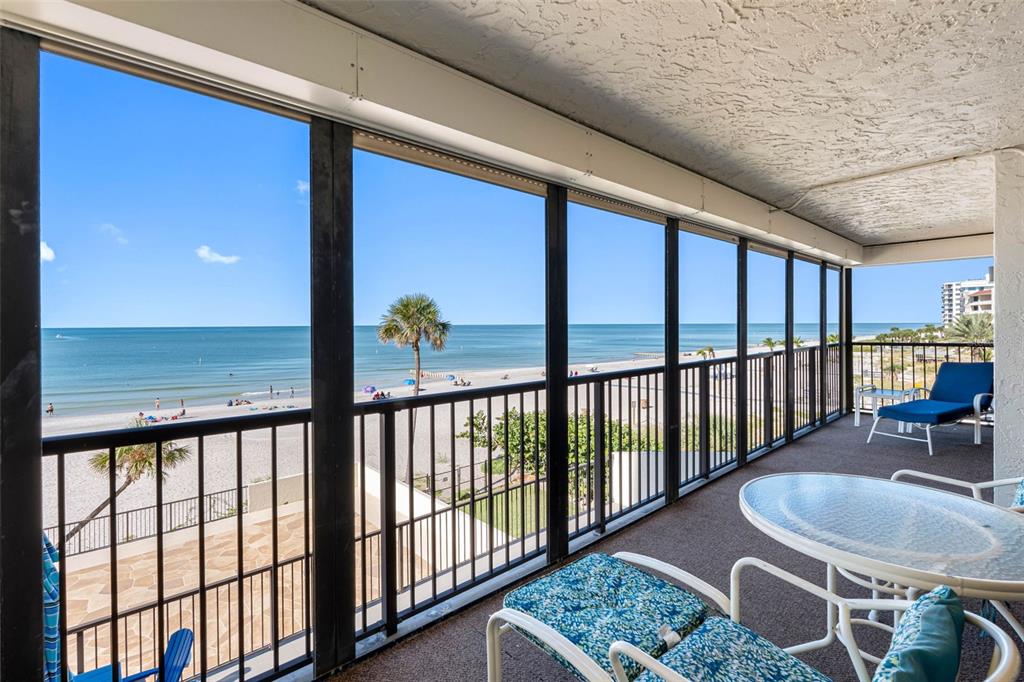 15000 Gulf Boulevard, Unit 408 Madeira Beach, FL 33708 - Photo 8 of 35 a view of a porch with furniture and floor to ceiling window