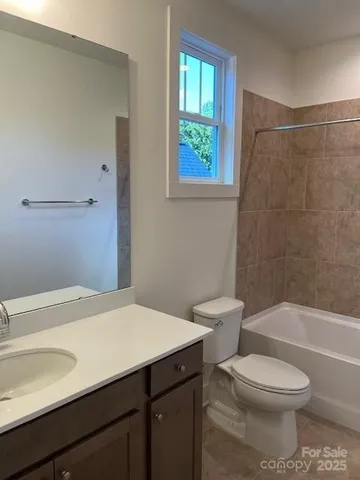 a view of a house with brick walls and a yard with plants