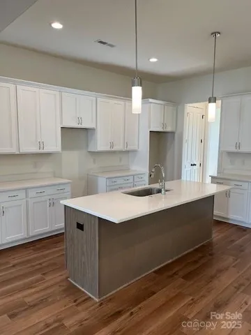 a kitchen with a sink window and cabinets