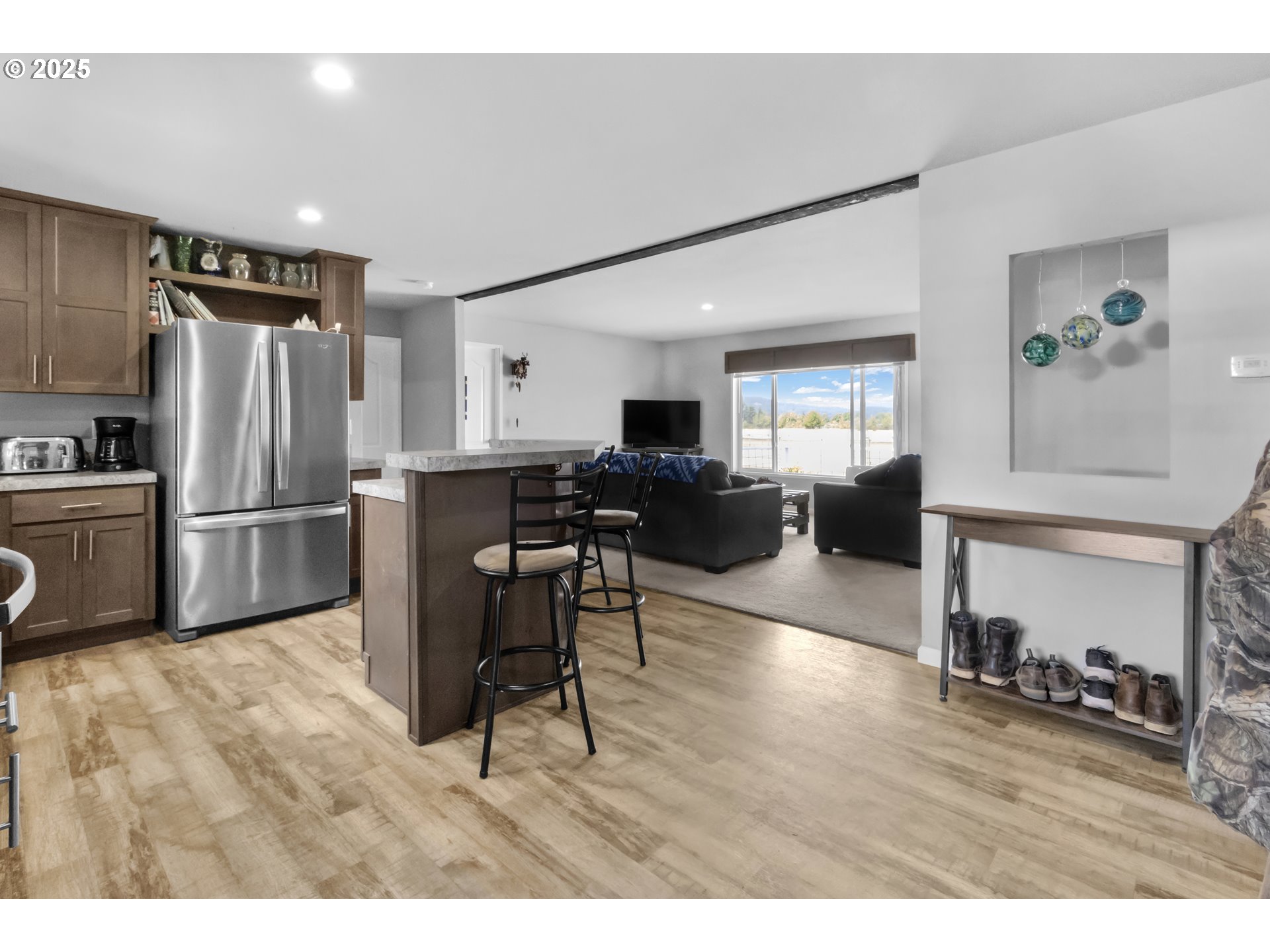 24550 Southwest Red Prairie Road Sheridan, OR 97378 - Photo 11 of 33 a kitchen with stainless steel appliances refrigerator wooden floor dining table and chairs