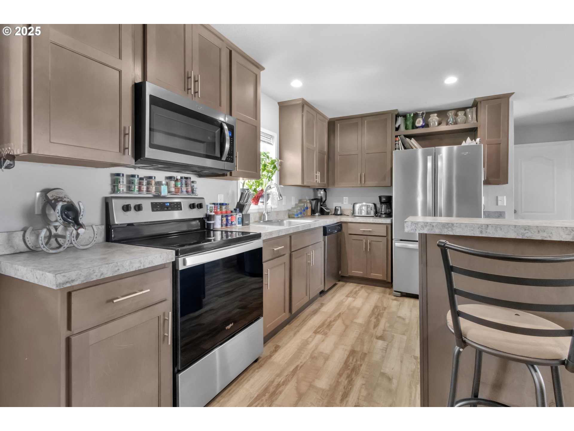 24550 Southwest Red Prairie Road Sheridan, OR 97378 - Photo 14 of 33 a kitchen with stainless steel appliances a sink cabinets and a stove top oven