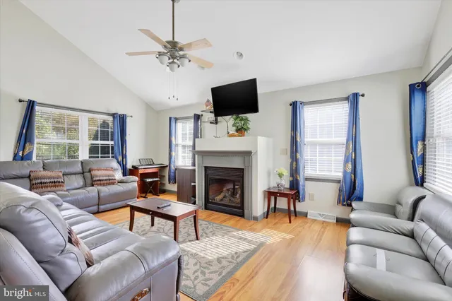 a living room with furniture a fireplace and a flat screen tv