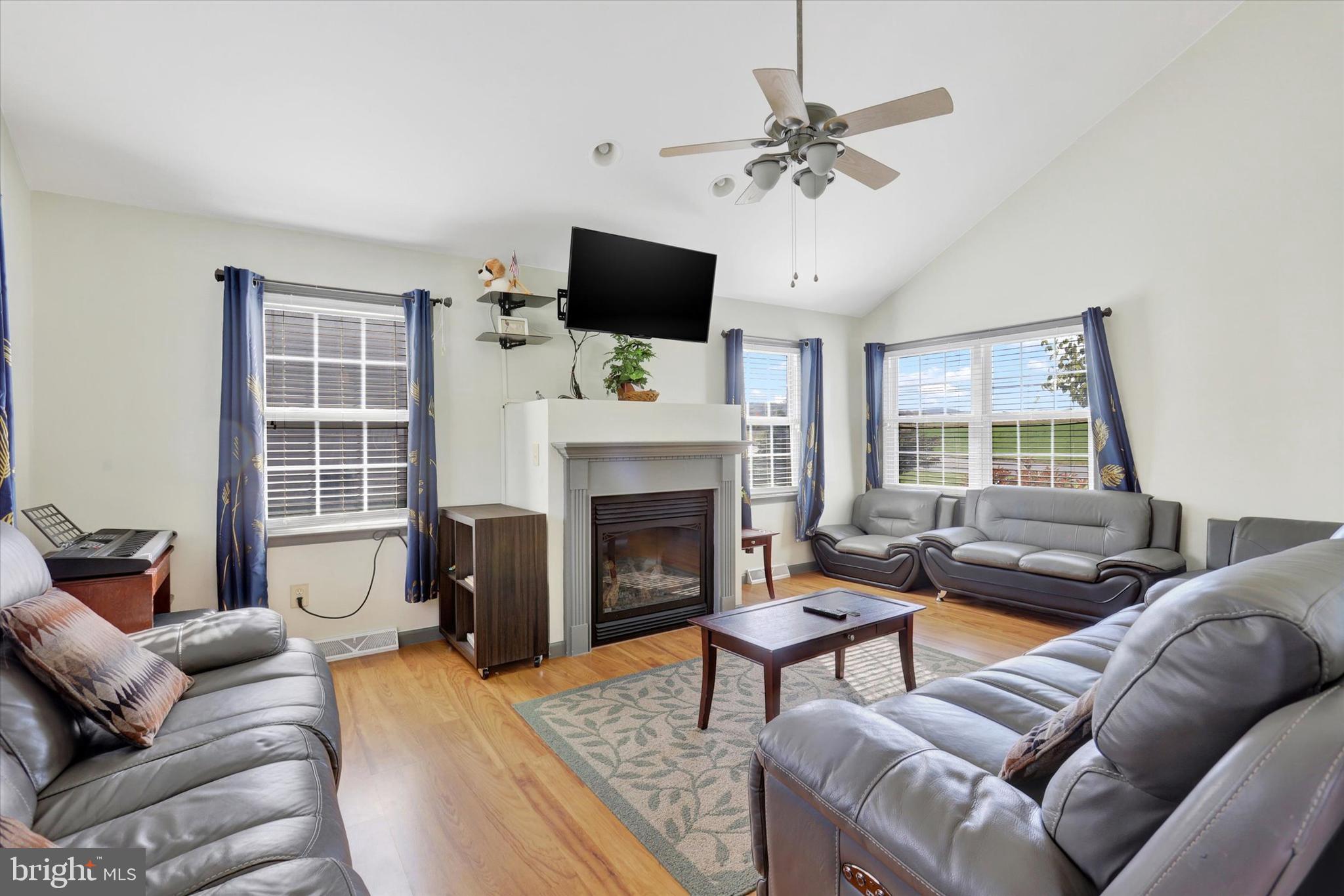 1109 Baltimore Road Shippensburg, PA 17257 - Photo 13 of 32 a living room with furniture a fireplace and a flat screen tv