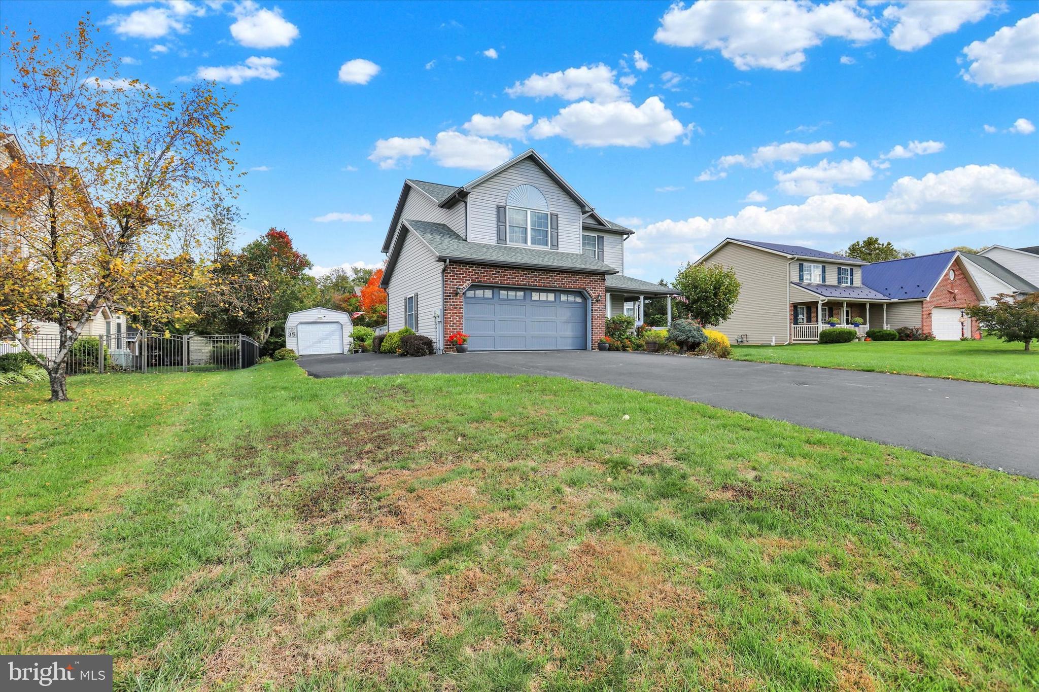 1109 Baltimore Road Shippensburg, PA 17257 - Photo 2 of 32 a front view of a house with a yard and garage