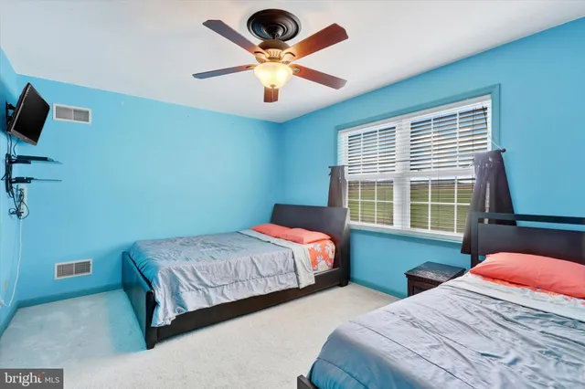 a bedroom with bed and window