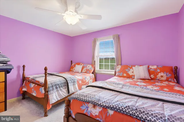 a bedroom with three beds and a chandelier