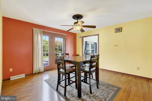 a view of a dining room with furniture and window