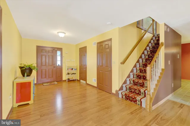 a view of an entryway with wooden floor