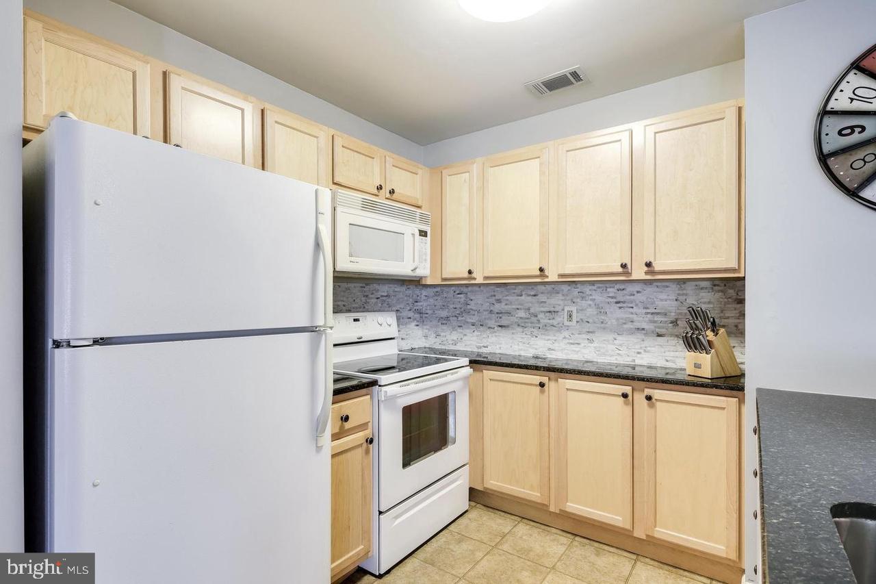 40 Greystone Court, Unit G Annapolis, MD 21403 - Photo 6 of 37 a white refrigerator freezer sitting inside of a kitchen