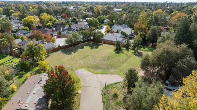 an aerial view of residential houses with outdoor space and swimming pool