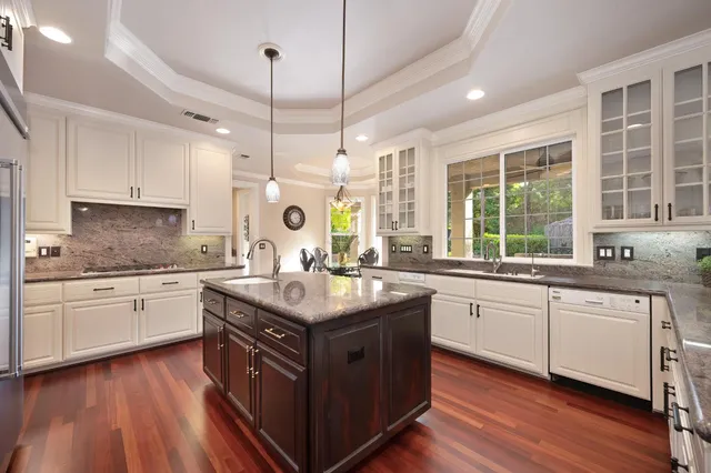 a living room with furniture ceiling fan and a large window