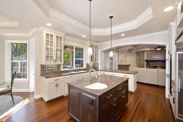 a kitchen with stainless steel appliances granite countertop a sink and a window