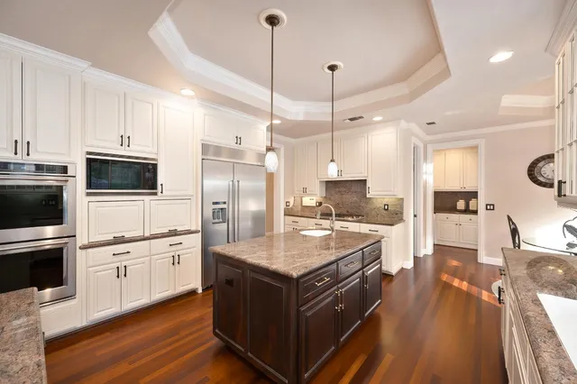 a kitchen with stainless steel appliances granite countertop a sink and a window