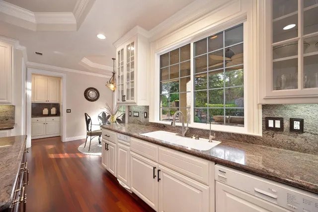 a living room with furniture a flat screen tv and a window