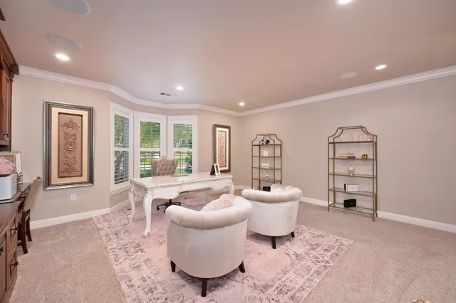 a spacious bedroom with a bed and glass door