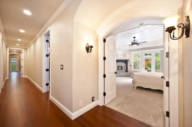 a spacious bedroom with a bed and glass door