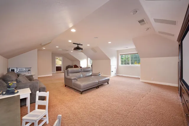 a backyard of a house with lots of green space and a fountain