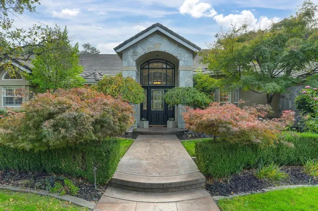 a view of a dining room with furniture a chandelier and wooden floor