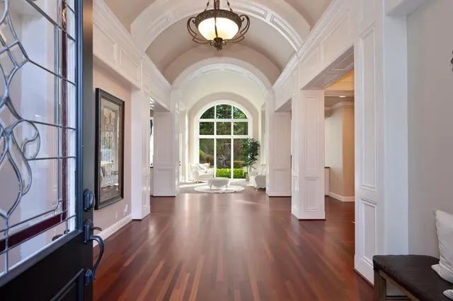 a view of a dining room with furniture a chandelier and wooden floor