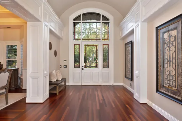 a large kitchen with stainless steel appliances and a white cabinets