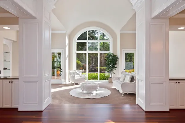 a dining room with furniture a chandelier and wooden floor