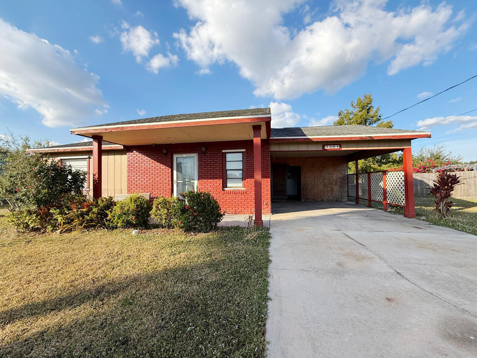 2361 Southeast 27th Street Okeechobee, FL 34974 - Photo 14 of 31 a front view of a house with a yard and garage