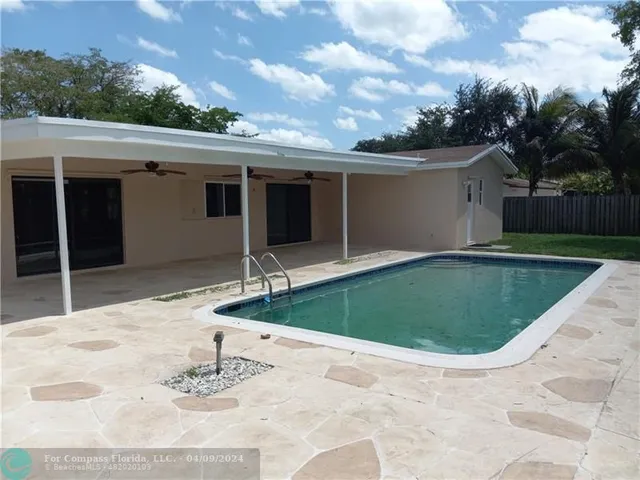 a view of a house with a backyard porch and sitting area