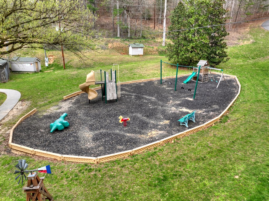 190 Village Road Murphy, NC 28906 - Photo 12 of 50 a view of a garden with a slide and a bench