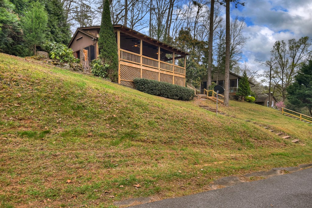 190 Village Road Murphy, NC 28906 - Photo 22 of 50 a backyard of a house with large trees and a wooden fence