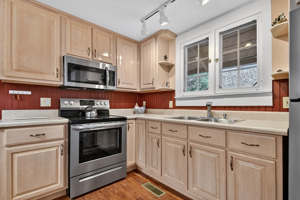 190 Village Road Murphy, NC 28906 - Photo 37 of 50 a kitchen with cabinets stainless steel appliances a sink and a window