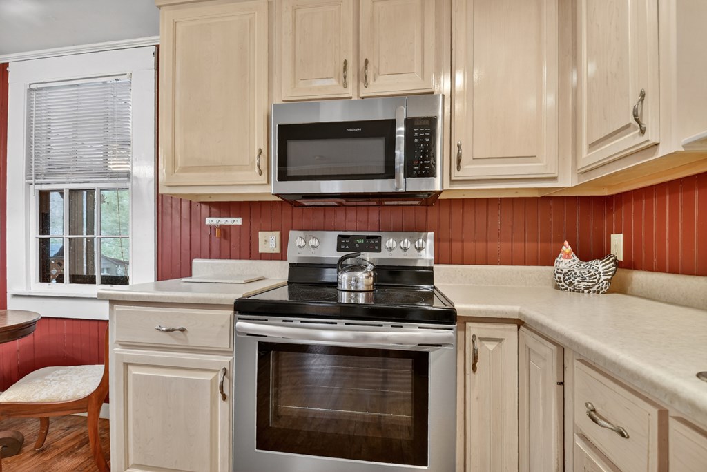 190 Village Road Murphy, NC 28906 - Photo 39 of 50 a kitchen with stainless steel appliances granite countertop a stove microwave and cabinets