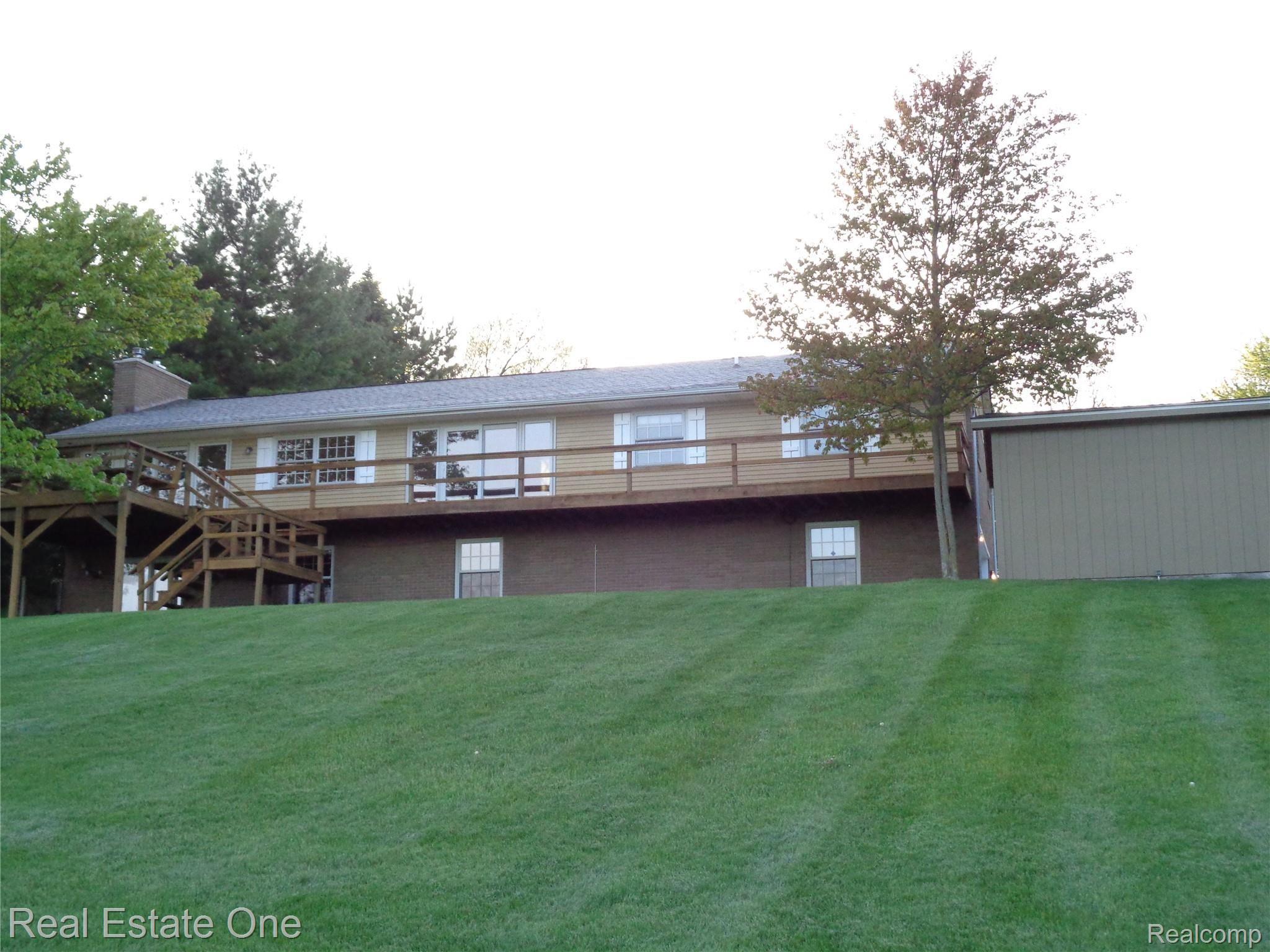 2572 Lake George Road Oakland, MI 48363 - Photo 66 of 83 Rear elevation, back of first shed is on the right