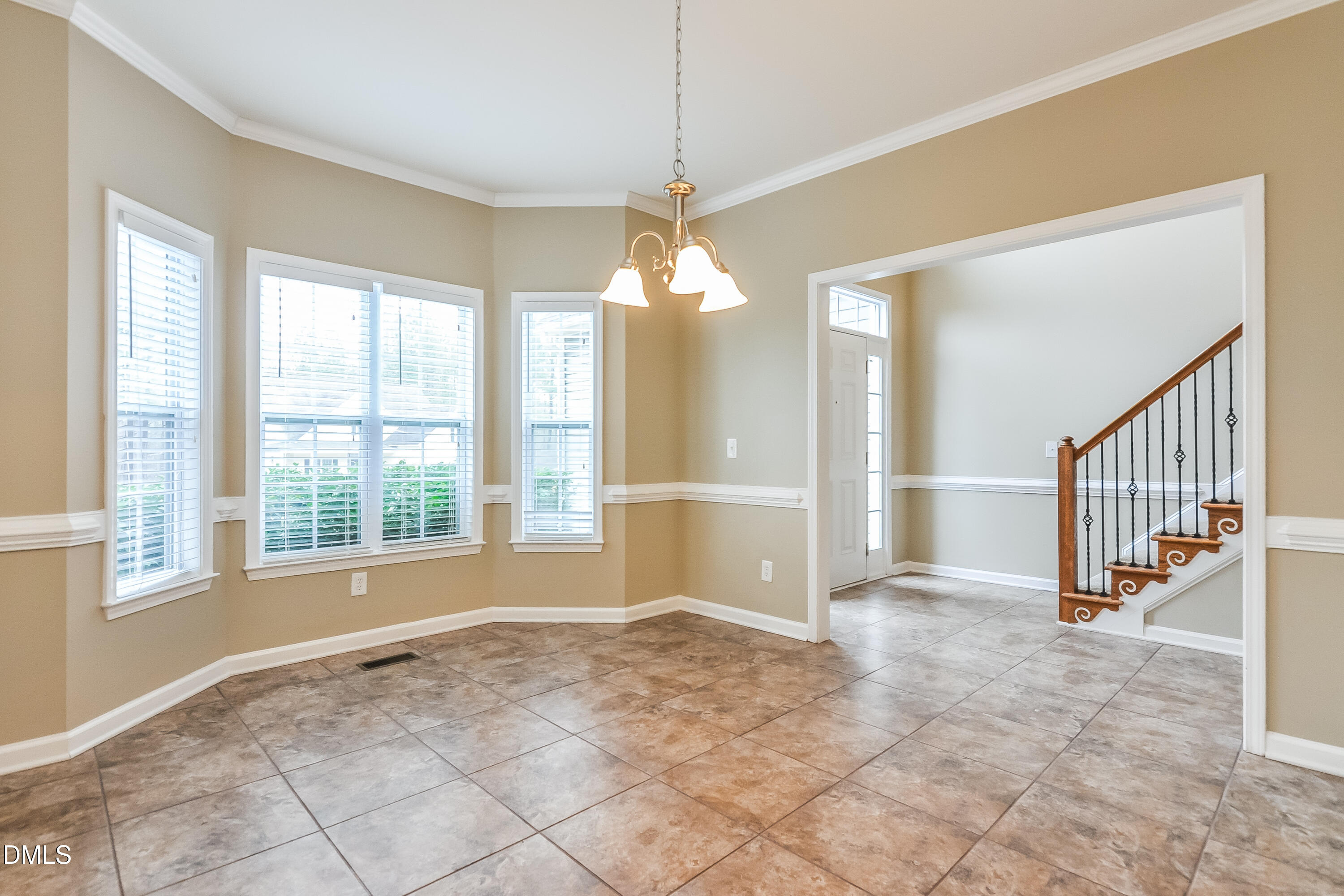 88 Meadow Loop Drive Clayton, NC 27527 - Photo 4 of 15 a view of an empty room with window chandelier fan and kitchen view