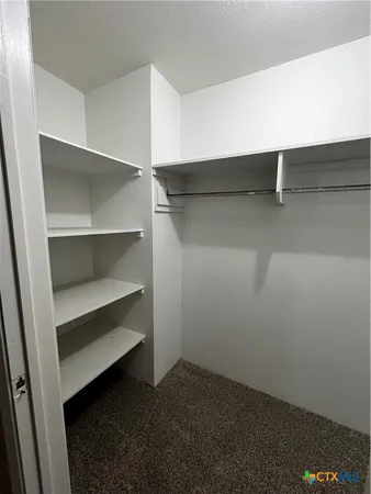 a view of an empty walk in closet