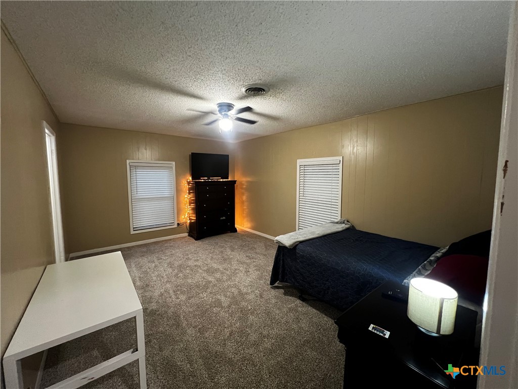 112 Stratford Street Victoria, TX 77905 - Photo 4 of 13 a bedroom with a bed and cabinets
