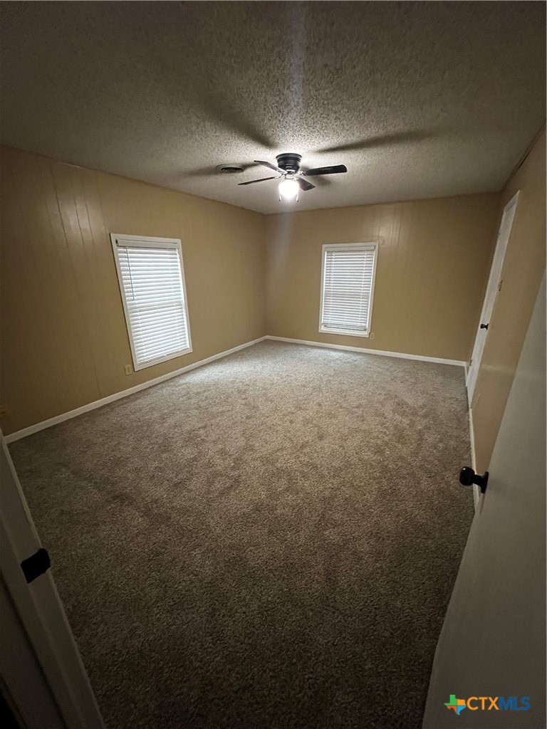 112 Stratford Street Victoria, TX 77905 - Photo 5 of 13 en empty room with windows and fan